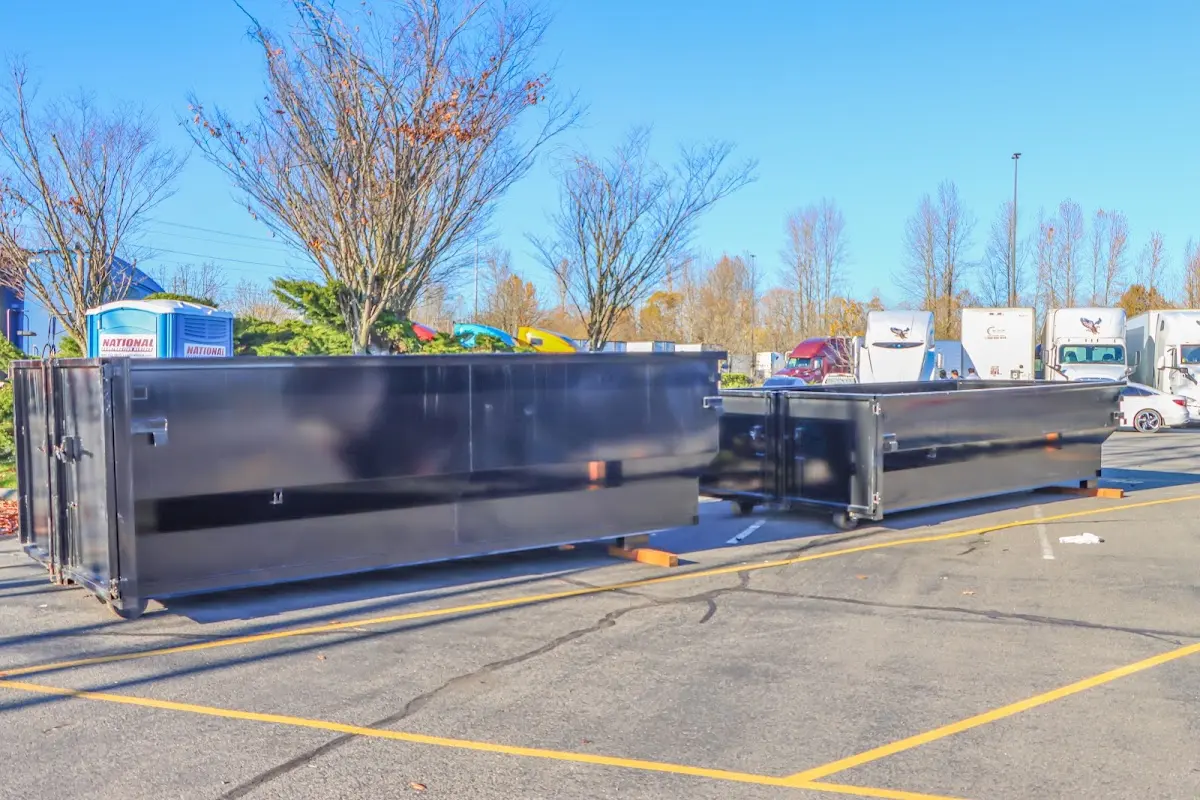 Professional dumpster rental service with roll-off container on residential driveway in Syracuse